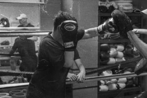 Grit boy behind boxing glove