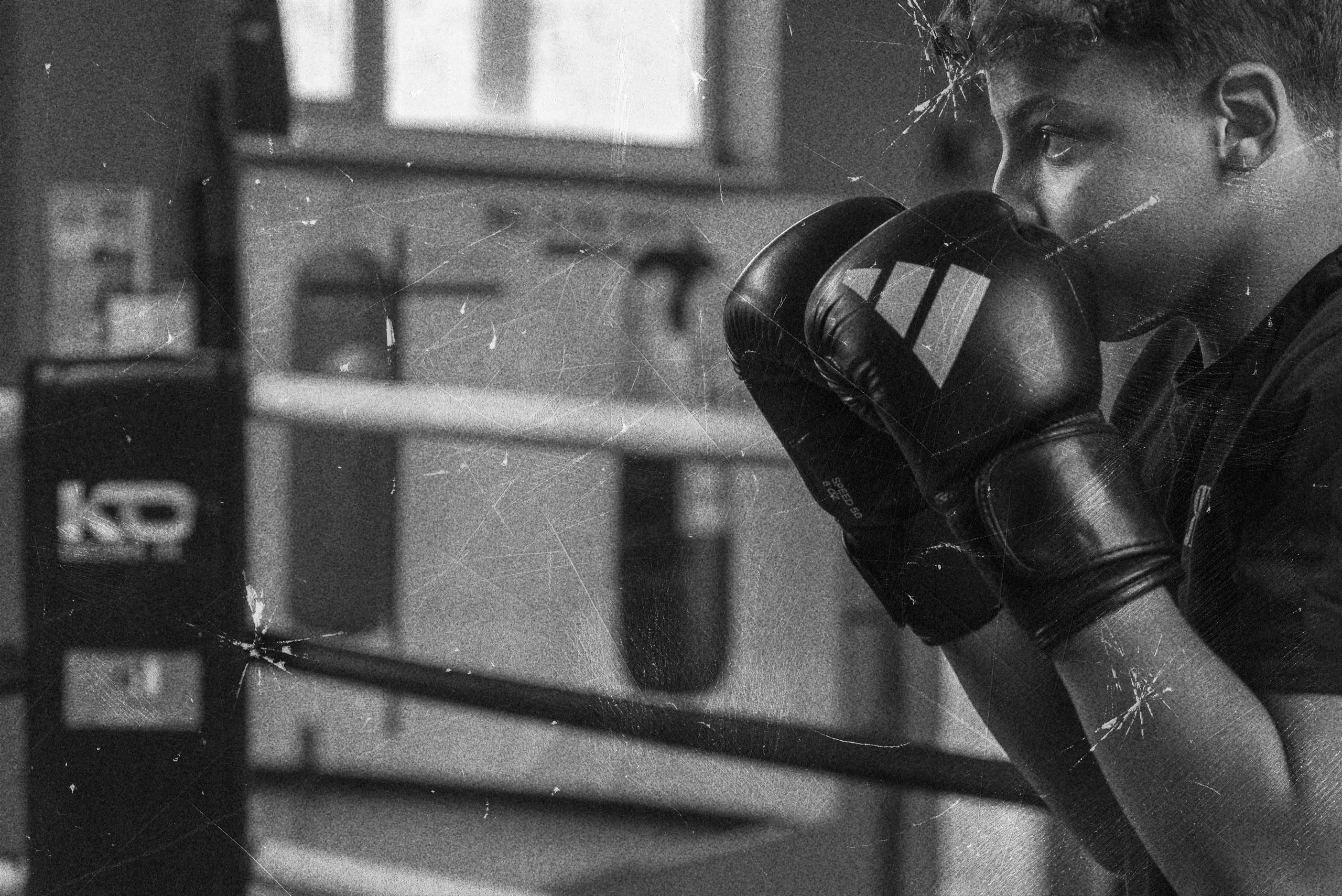 Grit boy looking through gloves