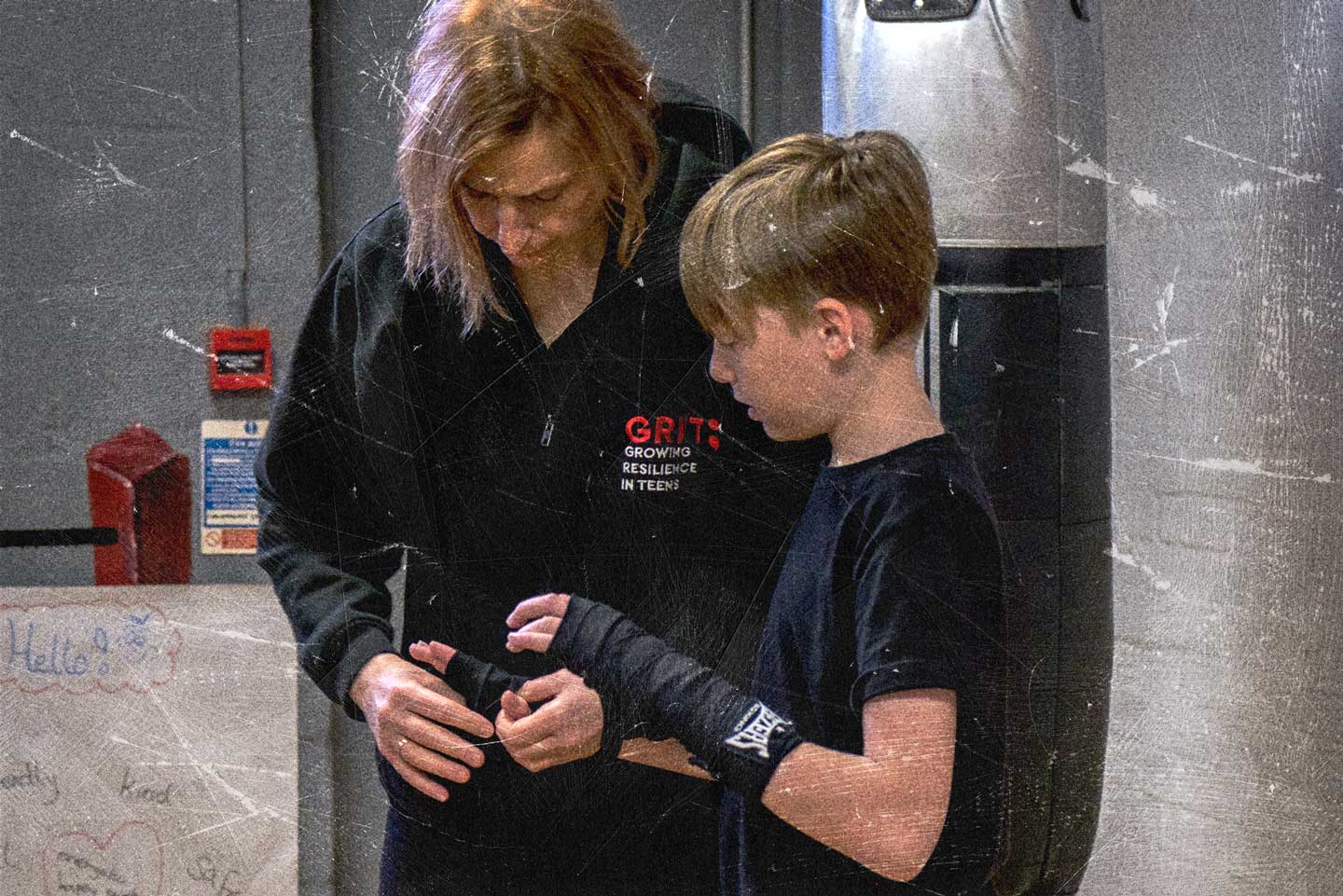 Trainer fixing boxing straps