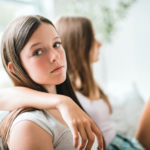 Two friends with one not speaking to the other